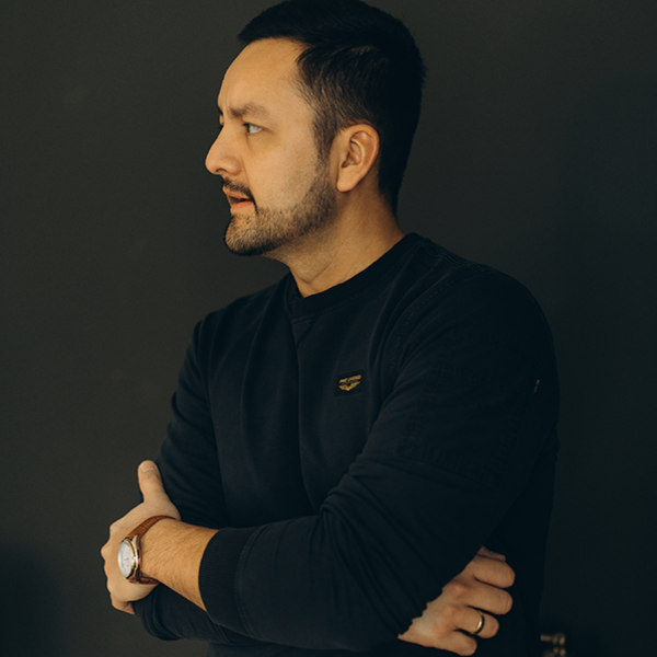 Alumnus Eduardo Rodriguez aus Mexiko blickt mit verschränkten Armen zur Seite