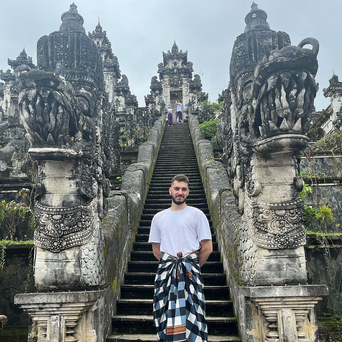 Niko Geljic in front of an imposing temple staircase in Asia