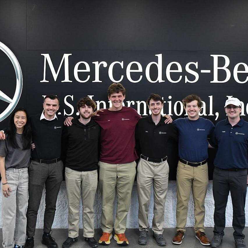 Photo with the U.S. Co-Ops of Mercedes-Benz United Statesstanding in front of a Mercedes-Benz branded background 