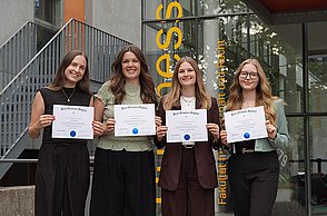 Four students celebrate their induction into the Beta Gamma Sigma honor society