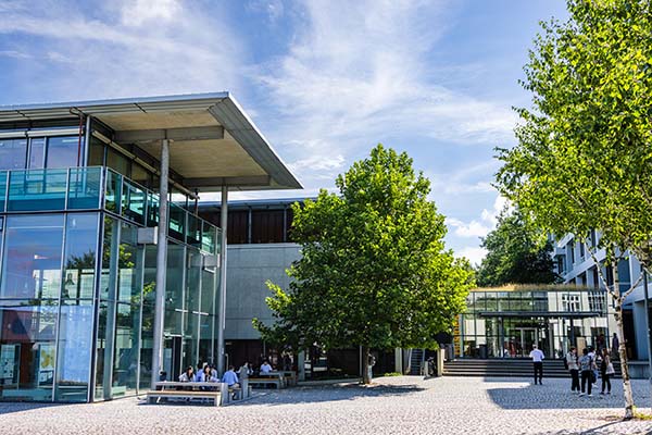 The lively summer campus of Pforzheim Business School with lush green trees